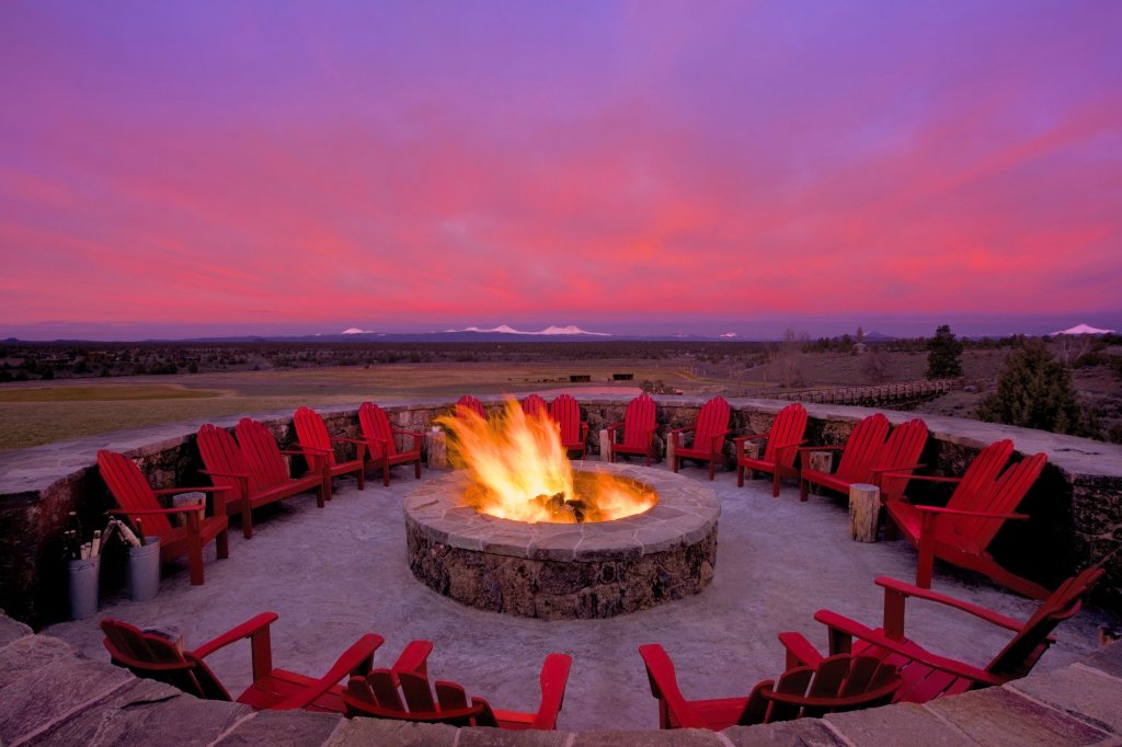 A purple and pink sunrise over a fire pit.